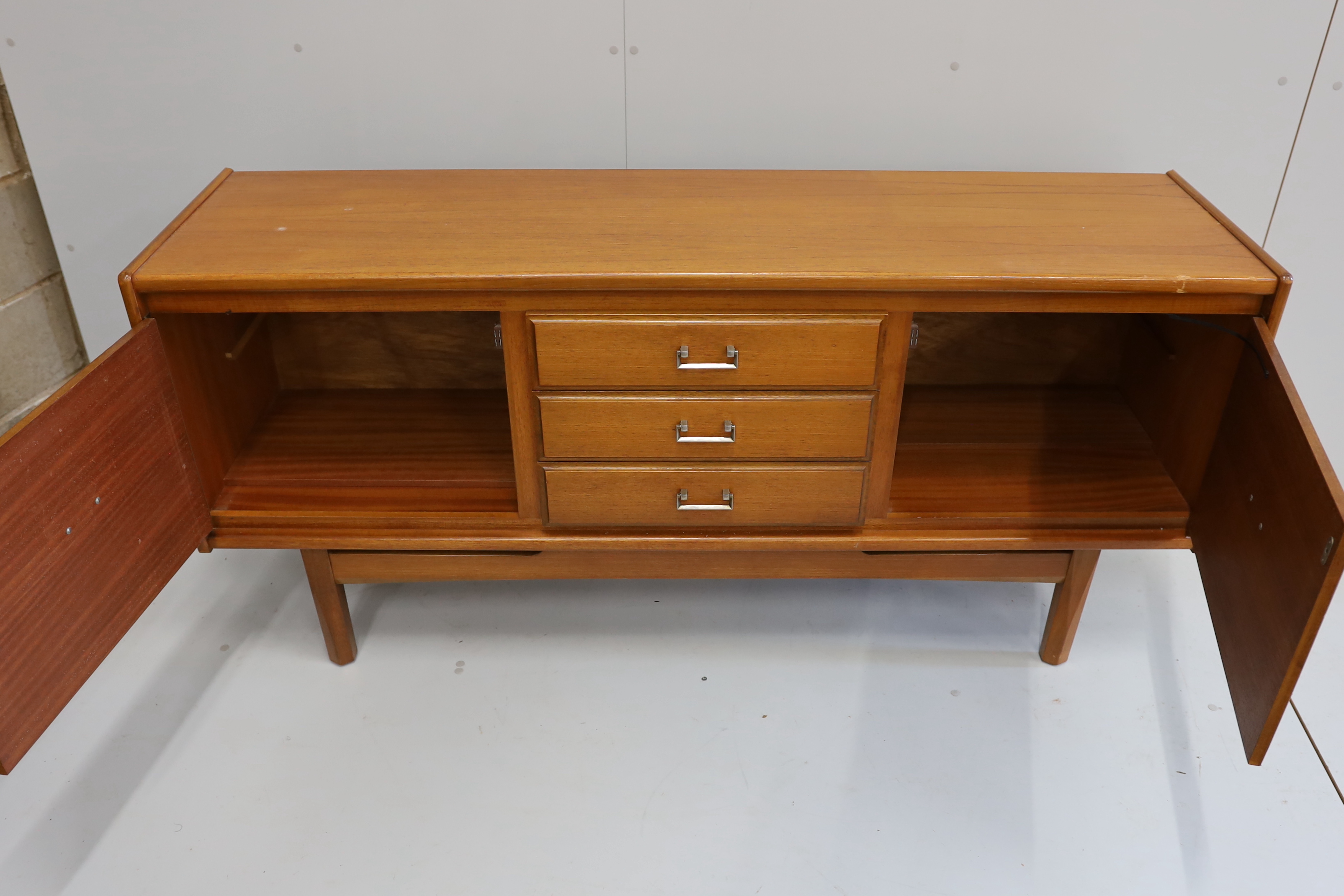 A mid century teak sideboard, bears William Lawrence label, width 163cm, depth 44cm, height 77cm